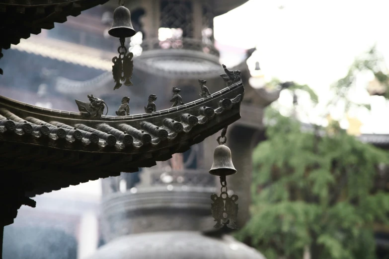 an oriental scene of bells and roof decorations