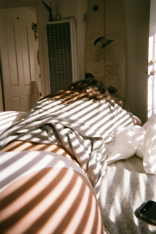 the girl is lying on a bed in the sunlight