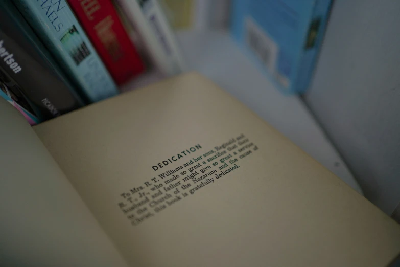 a blurry image of the book's title is on top of a shelf with books