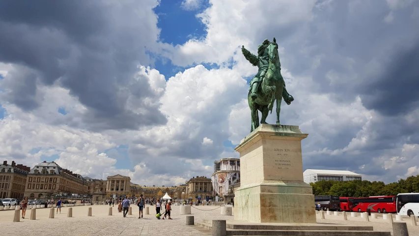 a statue in the middle of a square with people