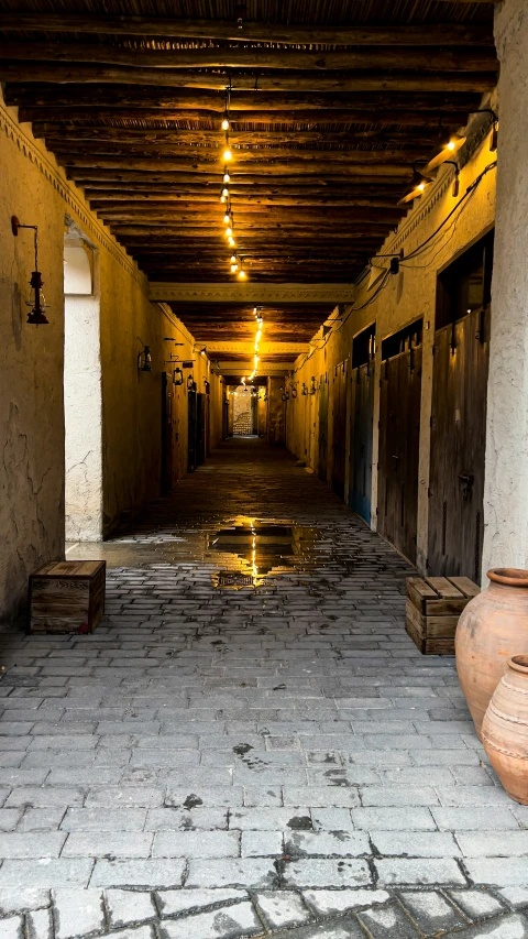 a walkway with urns on either side is lit up