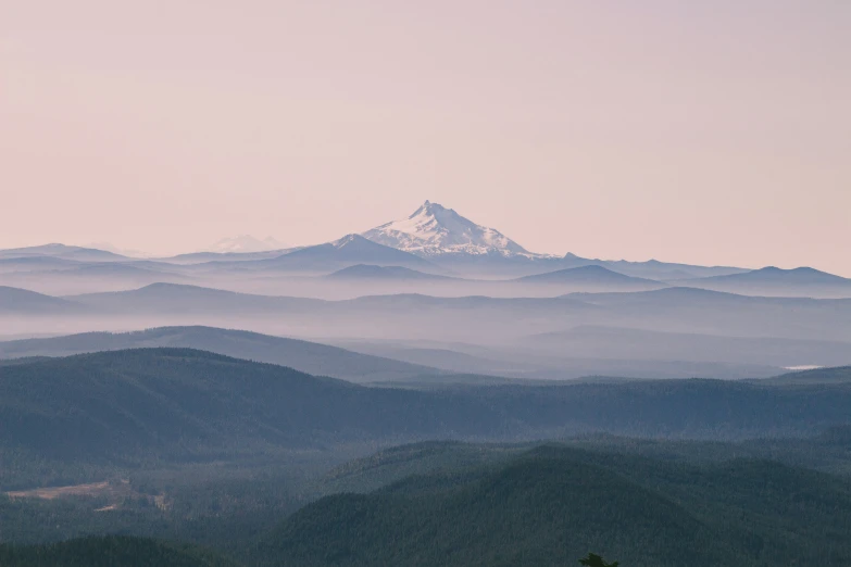 the mountain range with mist in the valley below