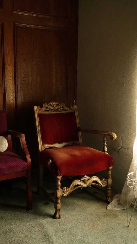 a room with two red and white chairs next to a doorway