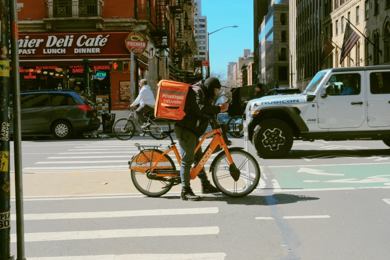 a person on a bike with a bag on it