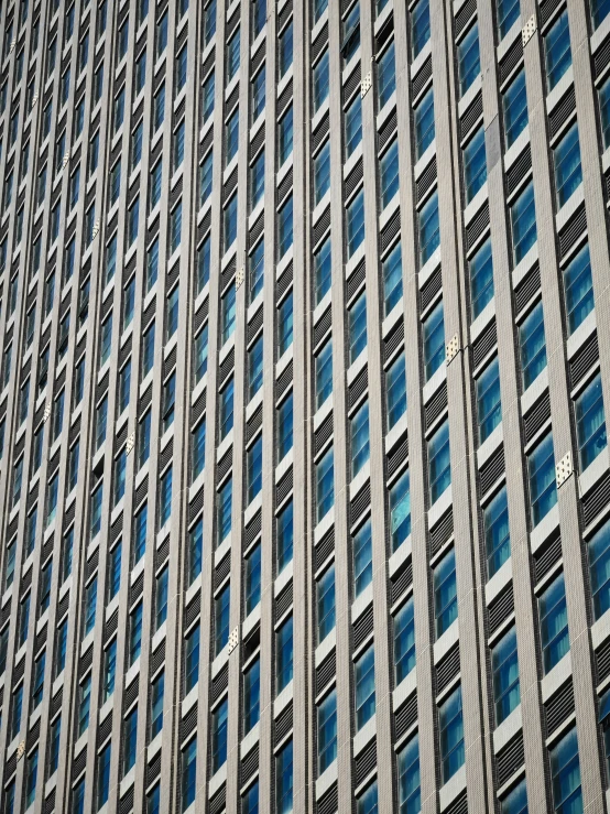 a very tall building with glass windows under the windows