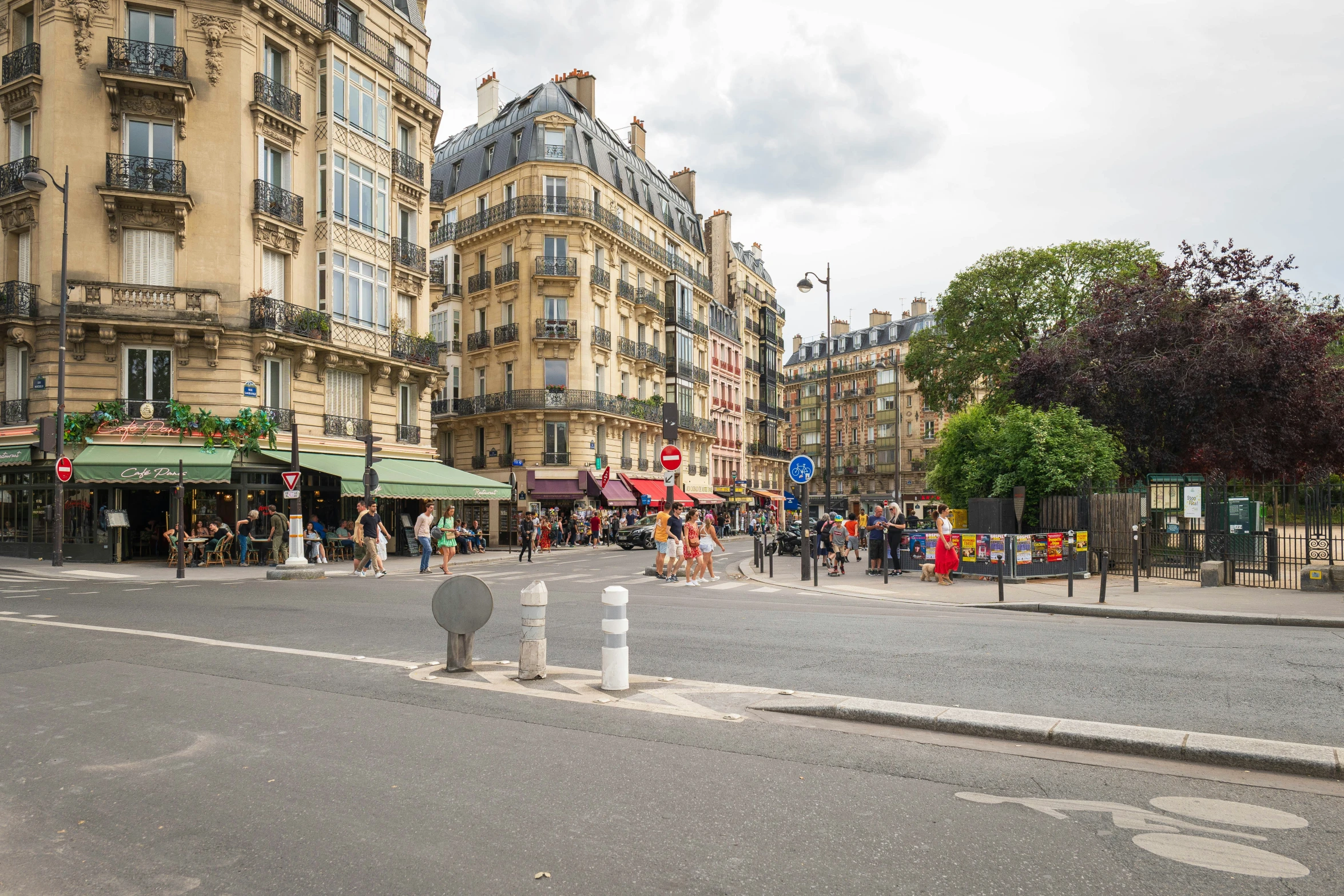 a row of buildings on a street with people on the side walk