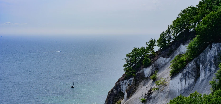 a lone person is paddling a surfboard on the ocean