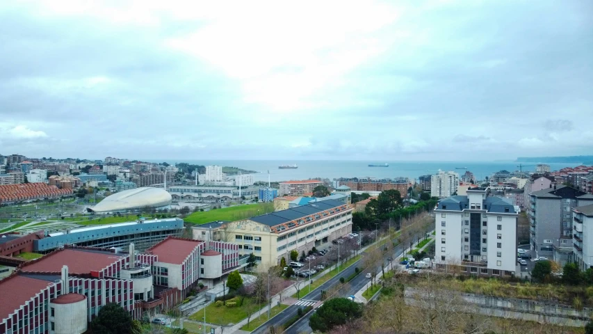 a city area with a street below it and buildings near the water