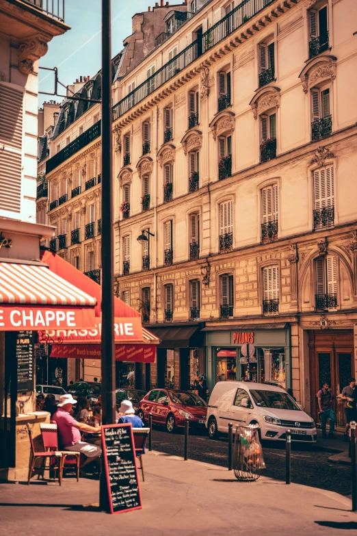 the sidewalk of a city with several buildings and cars