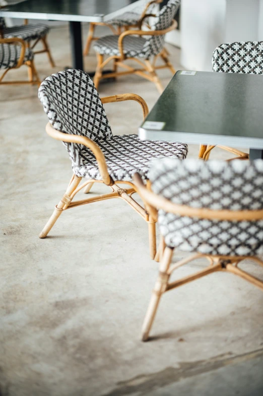 a restaurant area with tables and chairs made out of bamboo