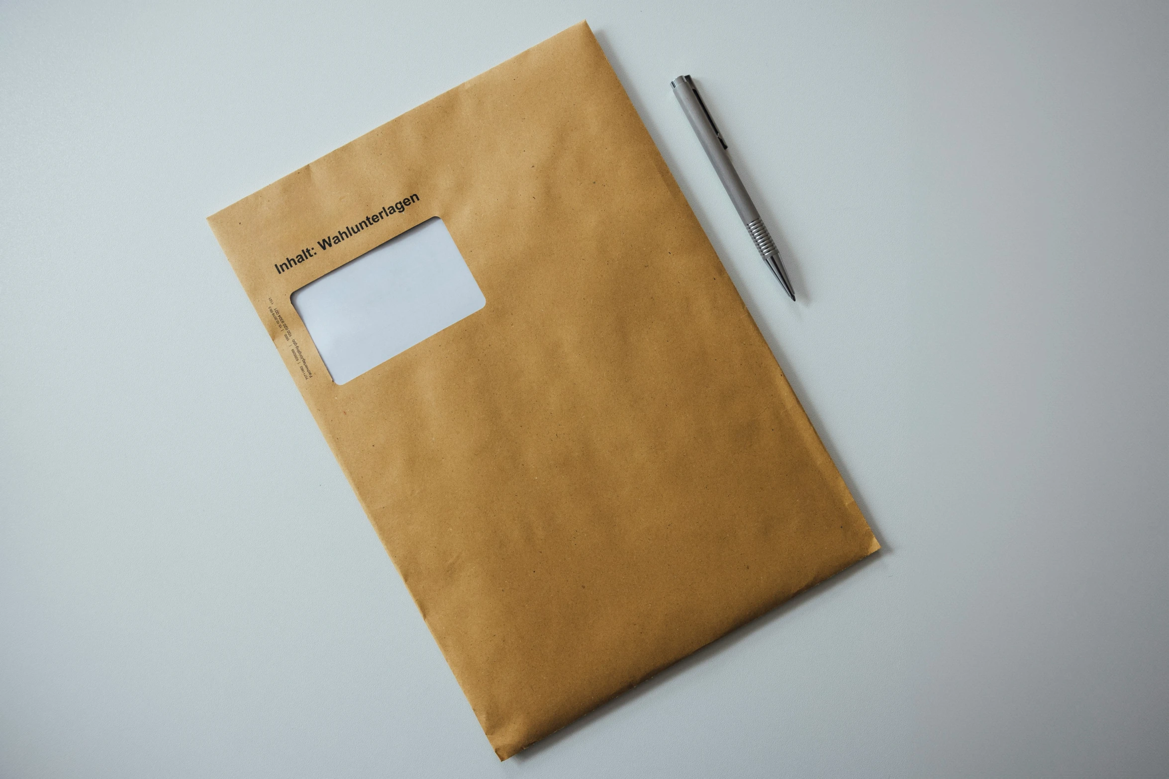 a piece of brown paper and a pen on top of it