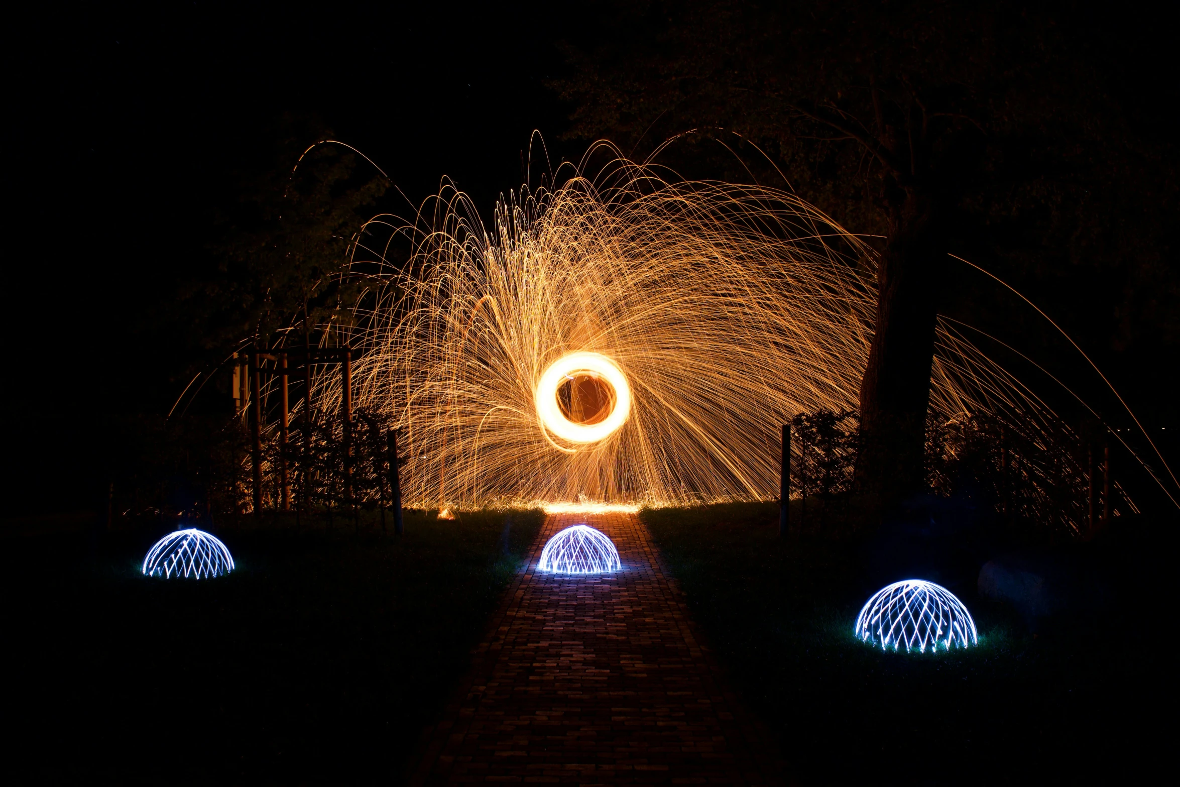 a light show of fire ring is in the air