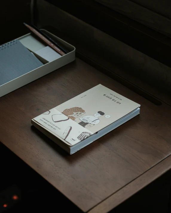 a notepad and a pen are on a desk