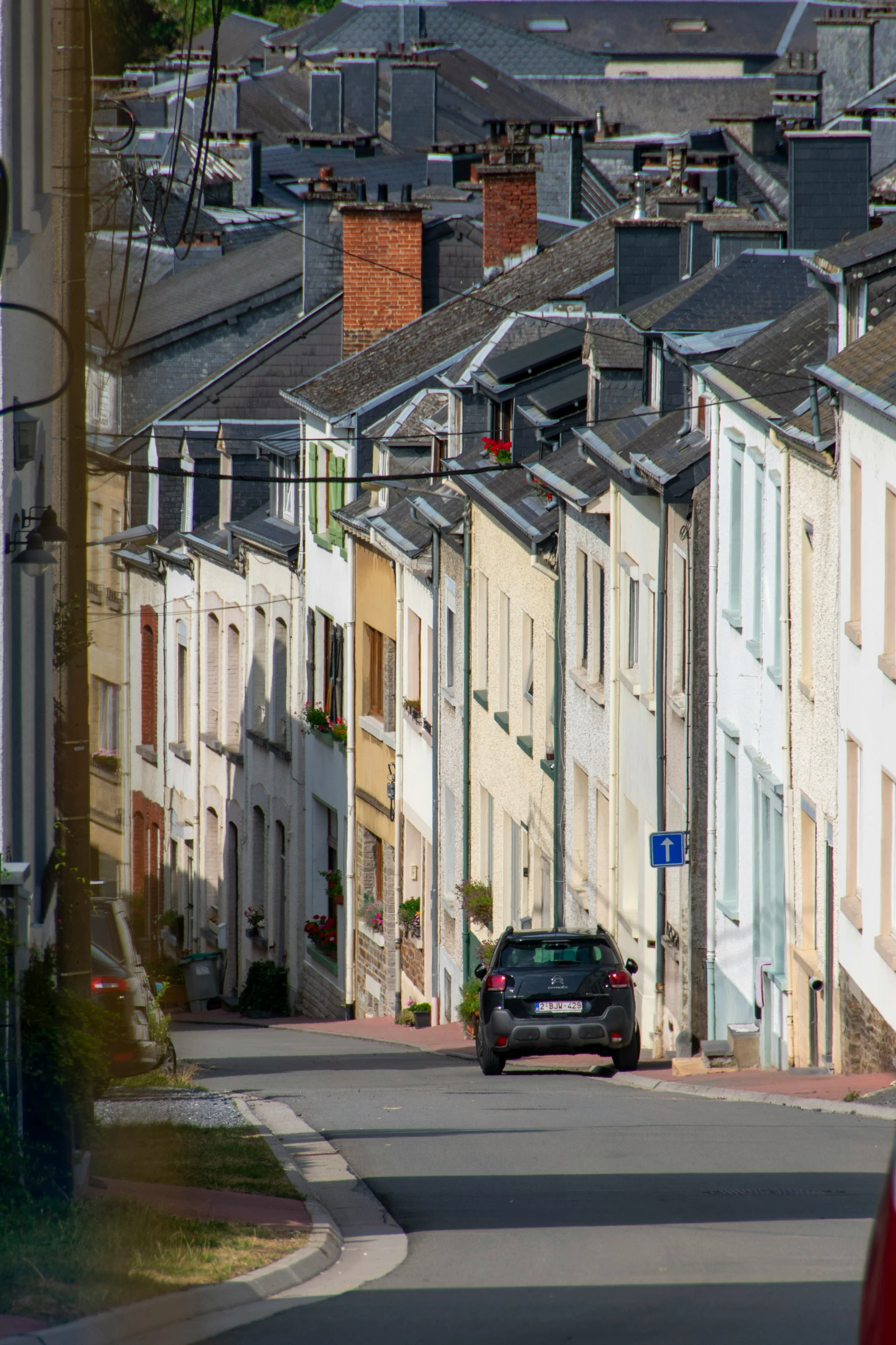 a car driving down the road through an old town