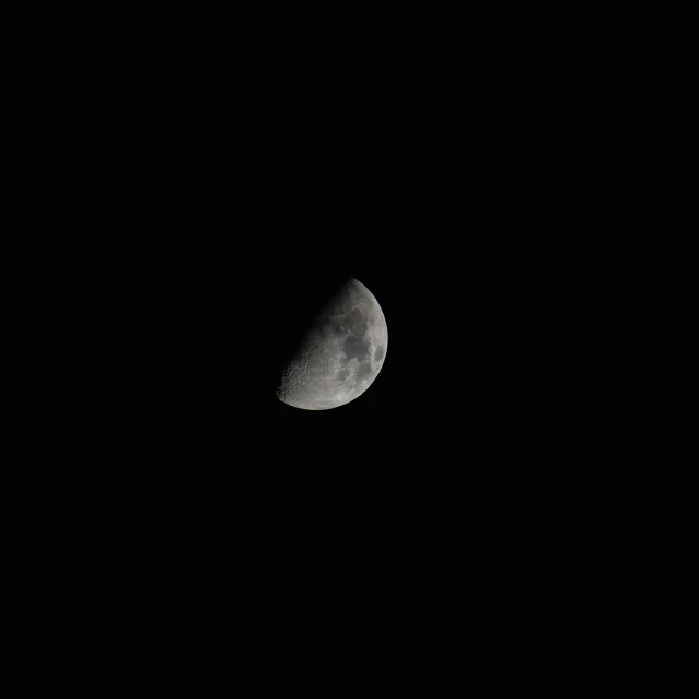 a half - moon is shown in the night sky