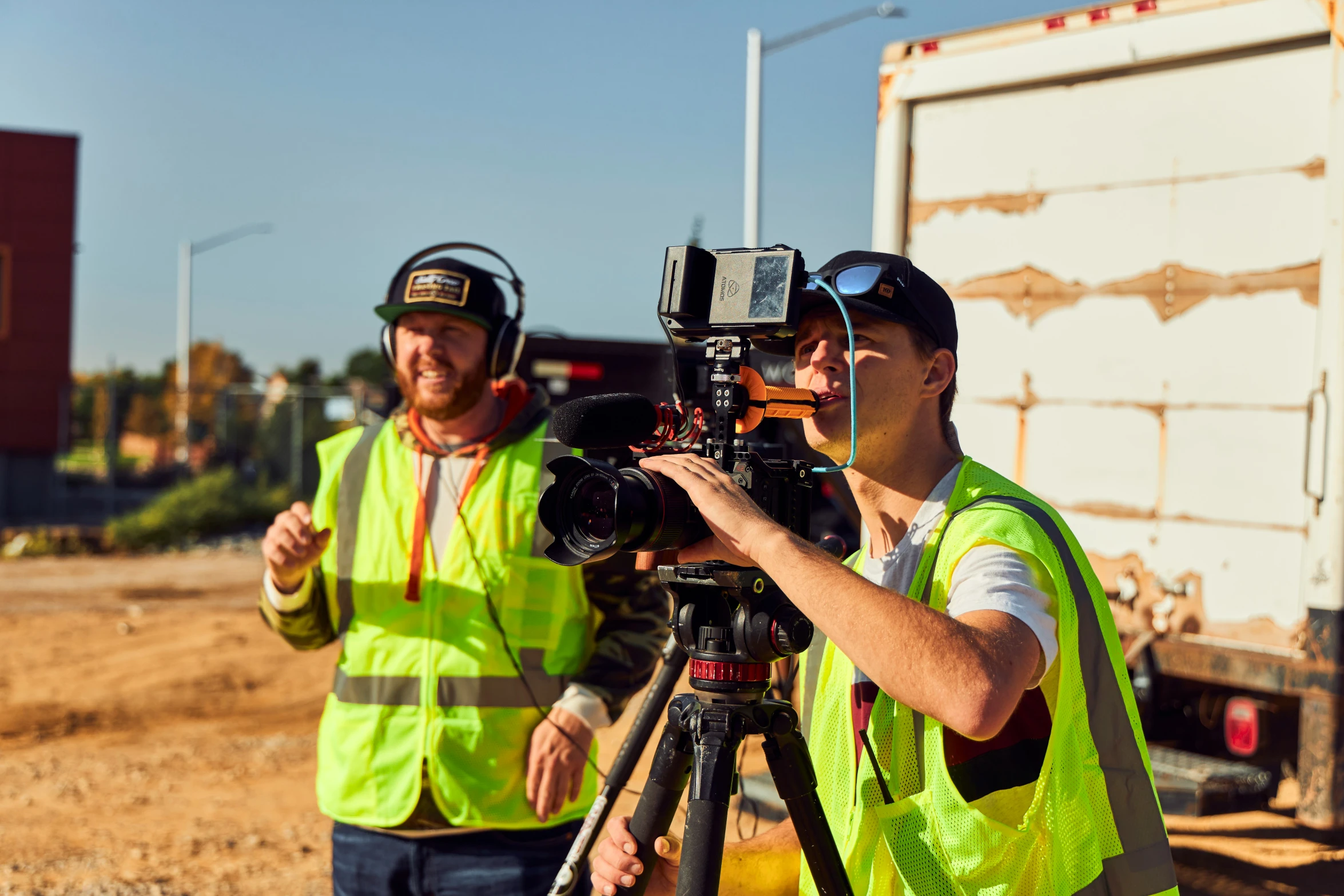 a couple of people in construction gear taking pictures