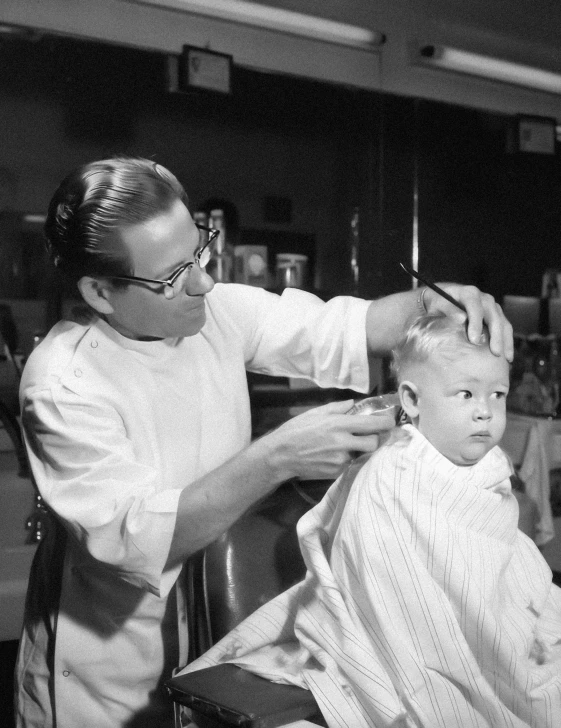 man  another mans hair in a barber shop