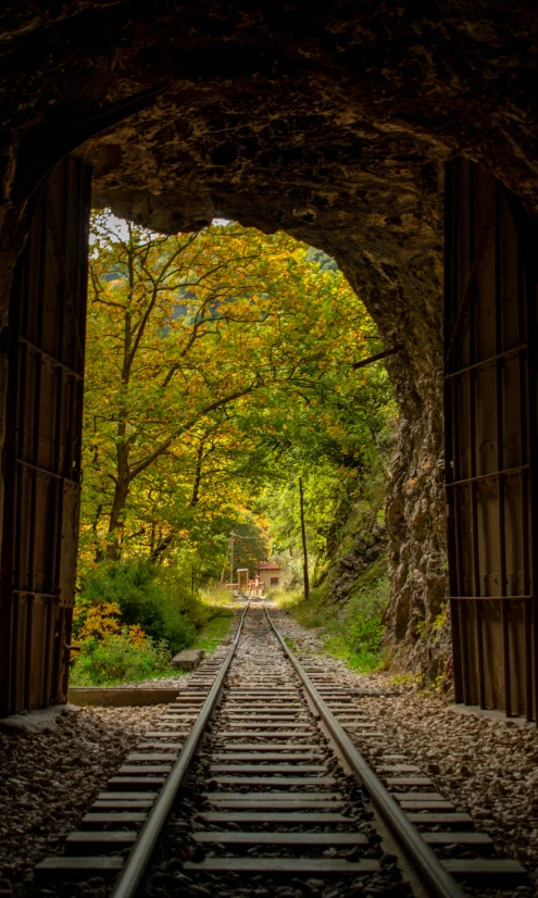 a railway track in front of a tunnel