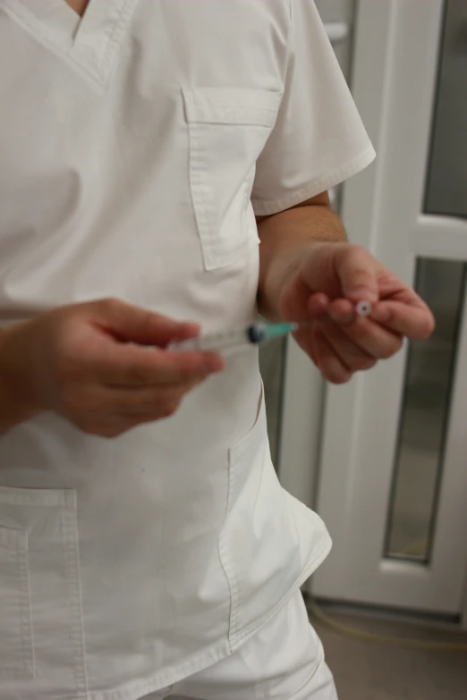 an image of a male surgeon putting soing on his hand