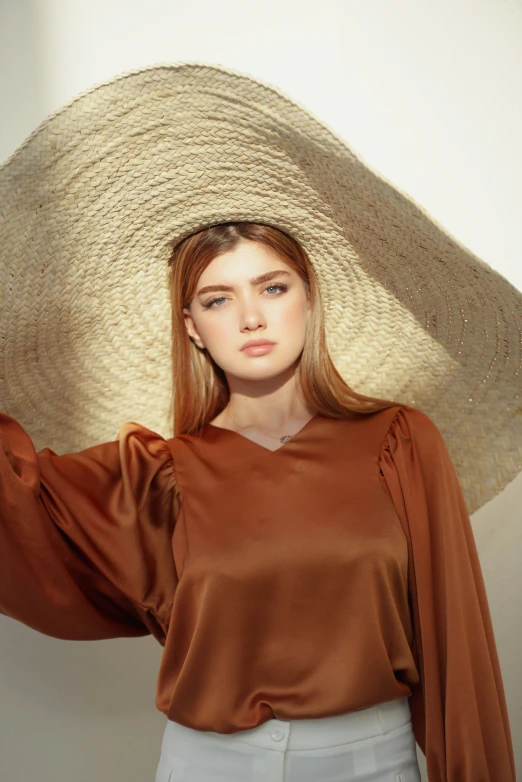 a woman standing next to a large straw hat