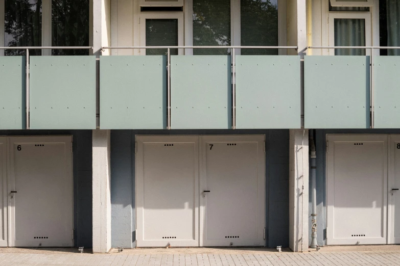 an empty wall and two doors on three buildings