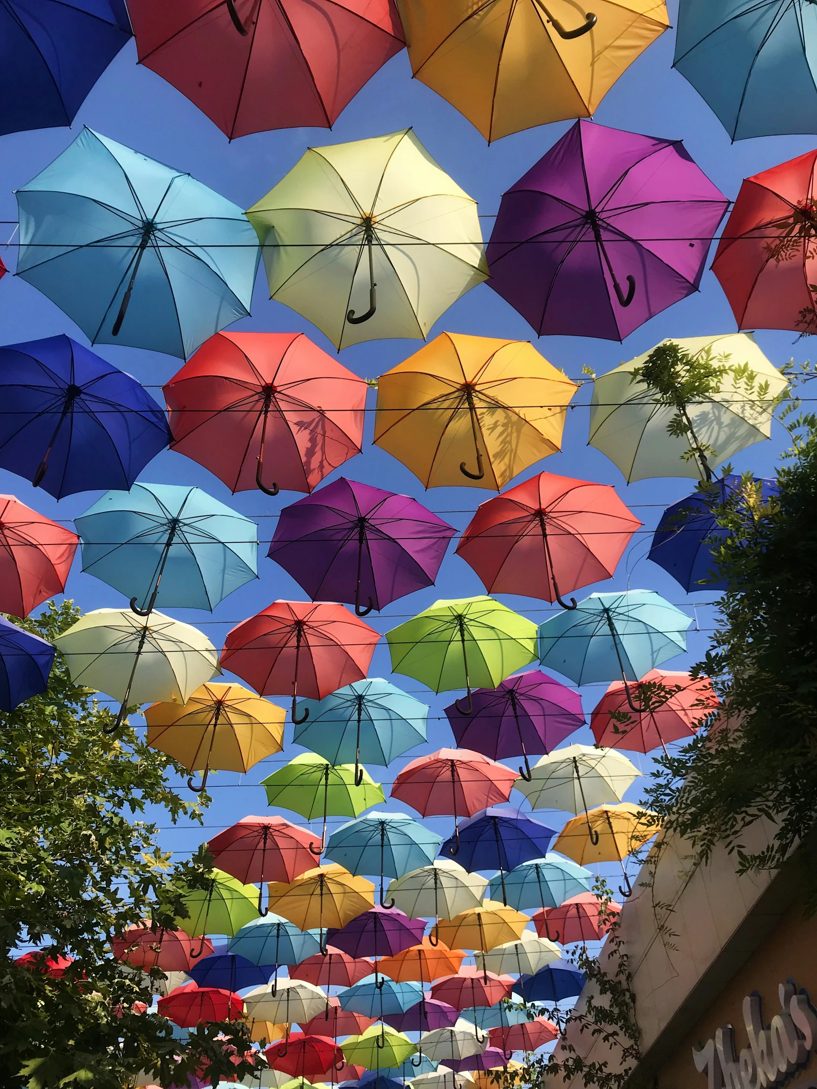 a group of umbrellas floating up in the sky