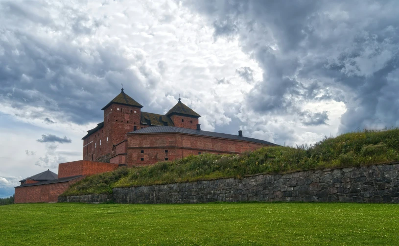 a large building on top of a green hill