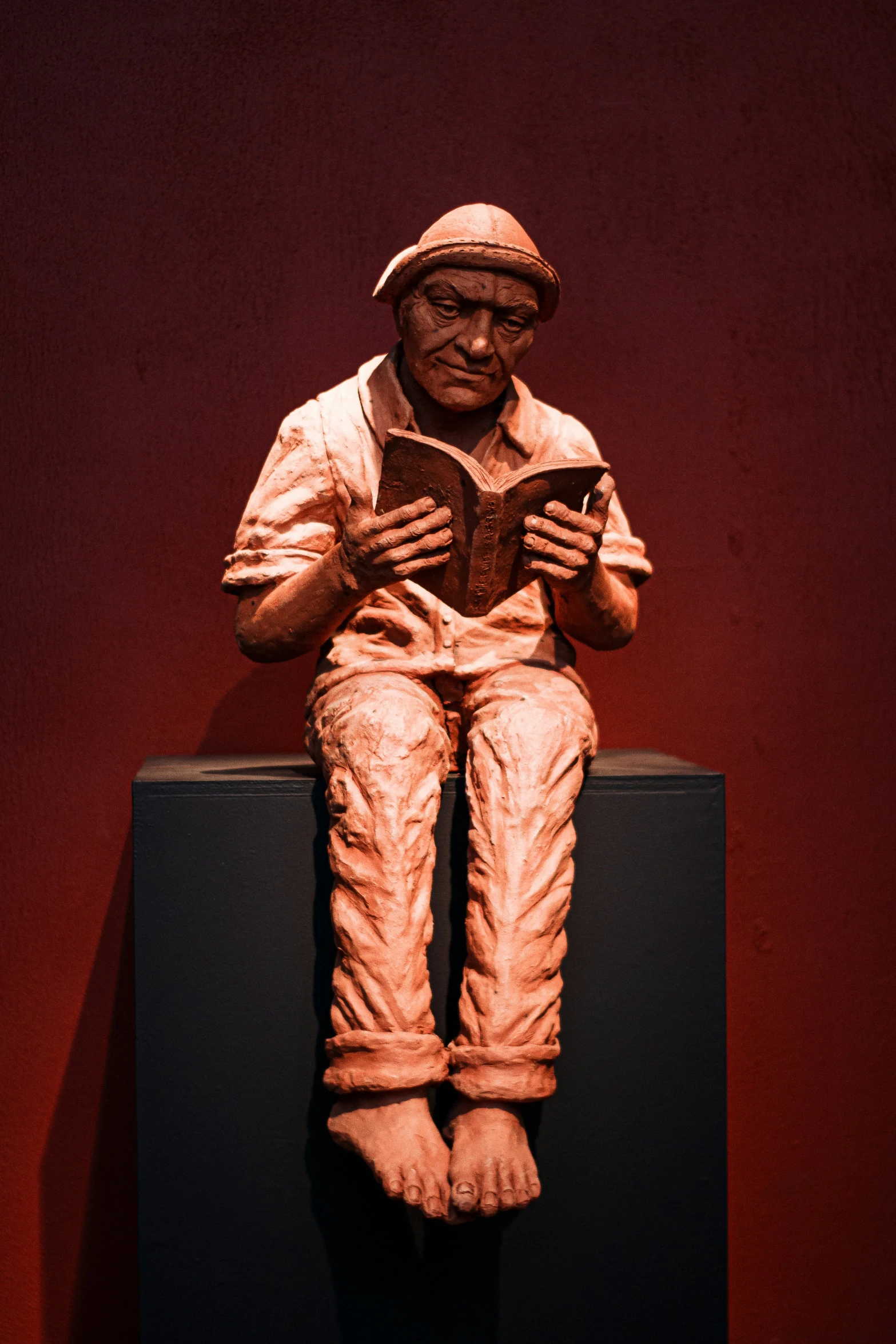 an artistically - carved statue sits atop a black box
