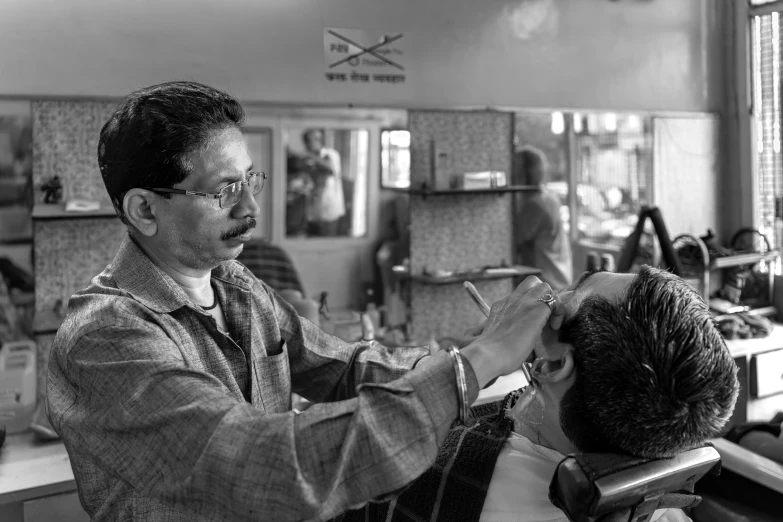 a black and white po of barber  mans hair