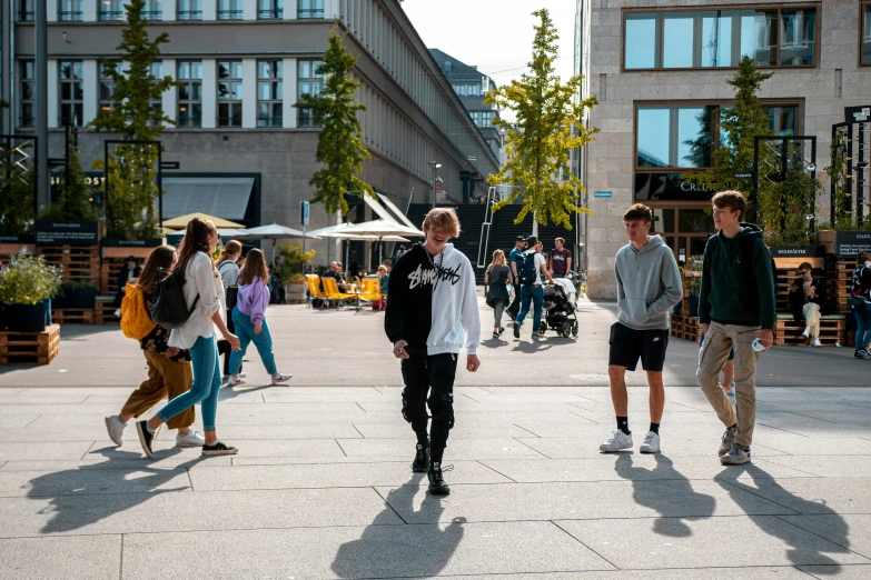 two men walking down a street past some buildings