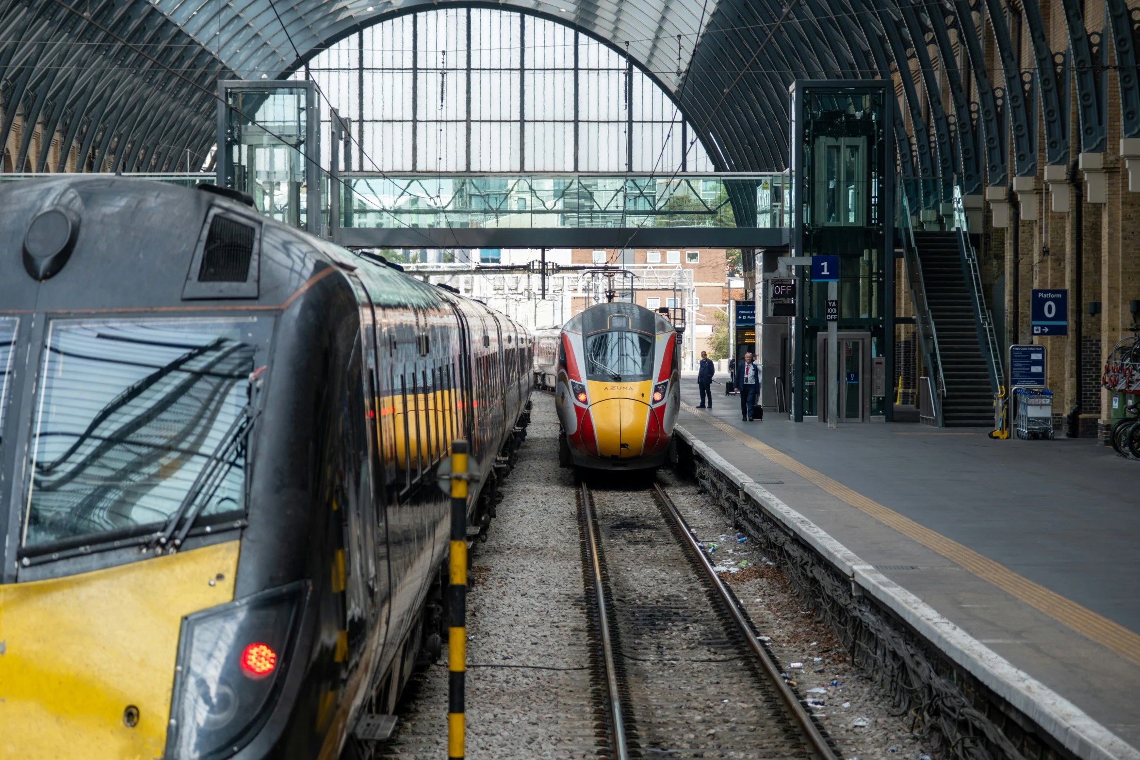 two trains are parked at a station next to each other