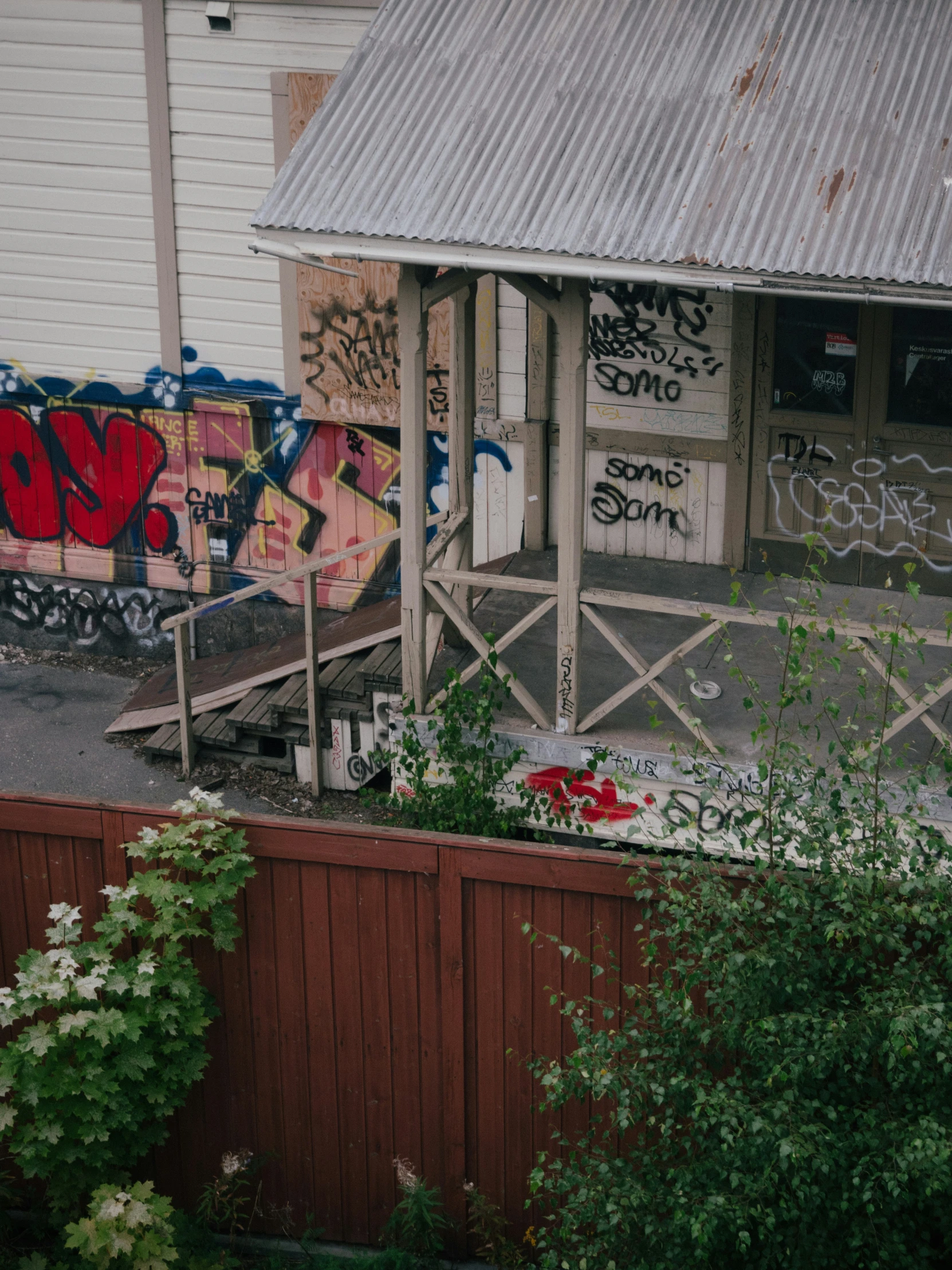 an old shed with grafitti on the walls