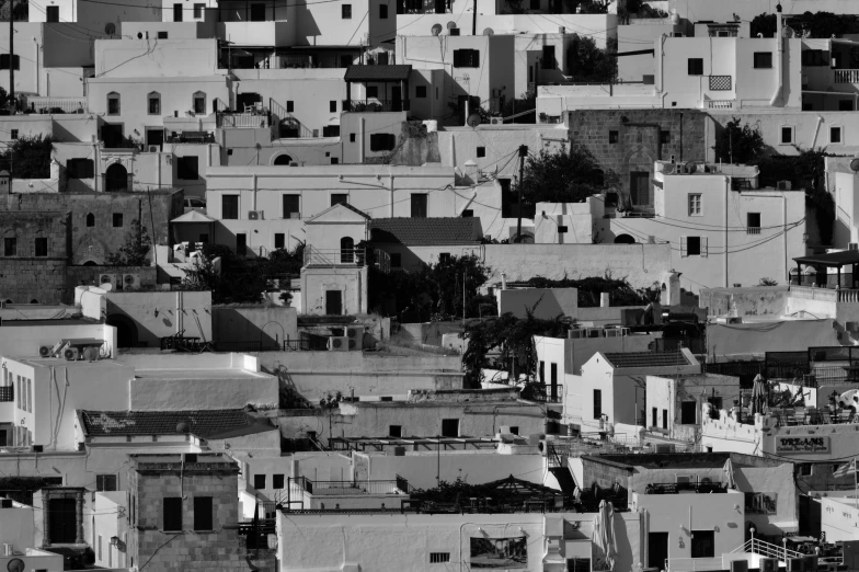 the top of several houses with roofs that are covered in buildings