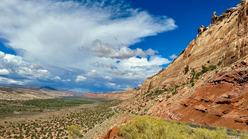 a big rock mountain by the side of some dirt road