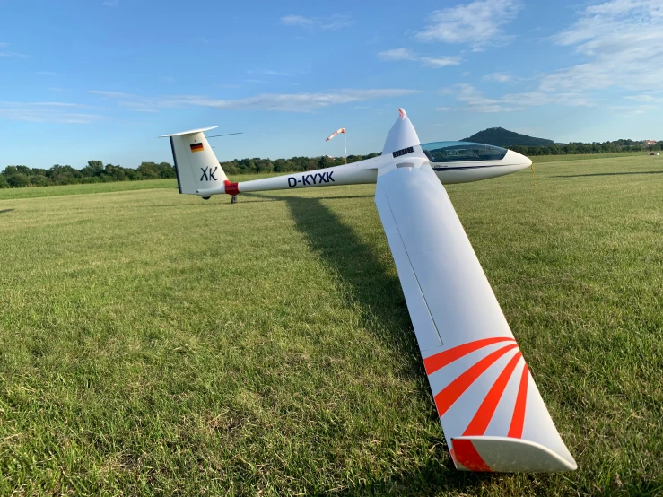 two airplanes on the grass near one another