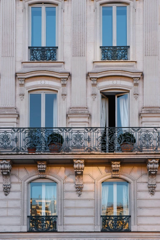 a building has ornate windows with balconies on them