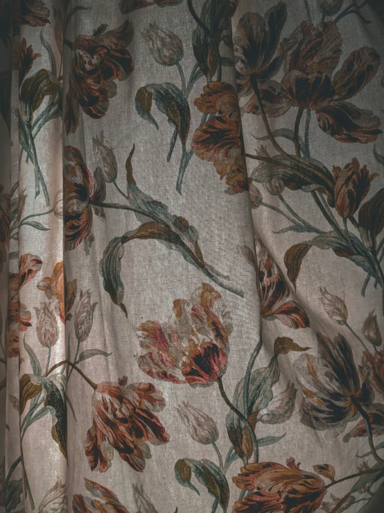 a curtain is adorned with floral fabric