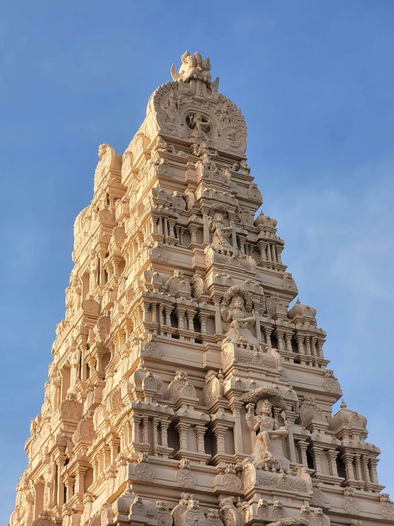 the very tall clock tower has many elaborate carvings