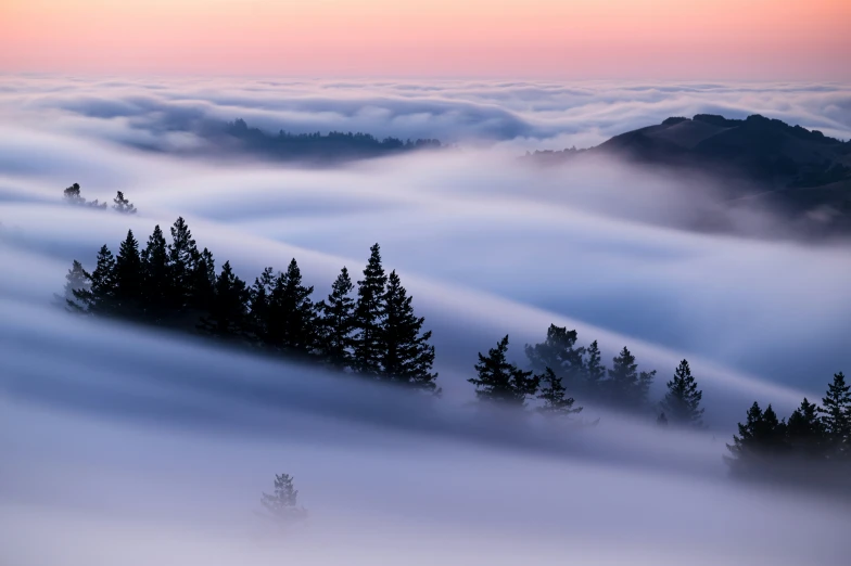 a landscape image with thick clouds and a mountain range in the distance