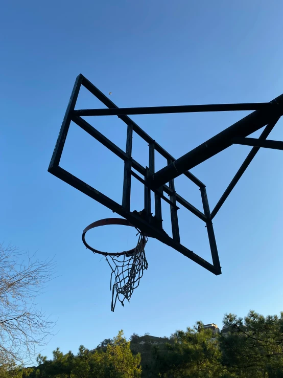 the basketball hoop is up in a clear blue sky