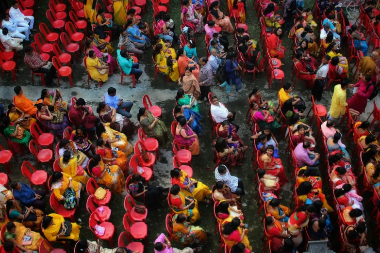 an aerial s of people sitting on red seats