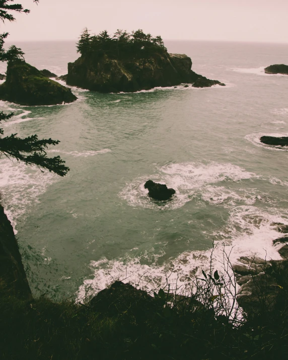 a view of the water with a few rocks in the background