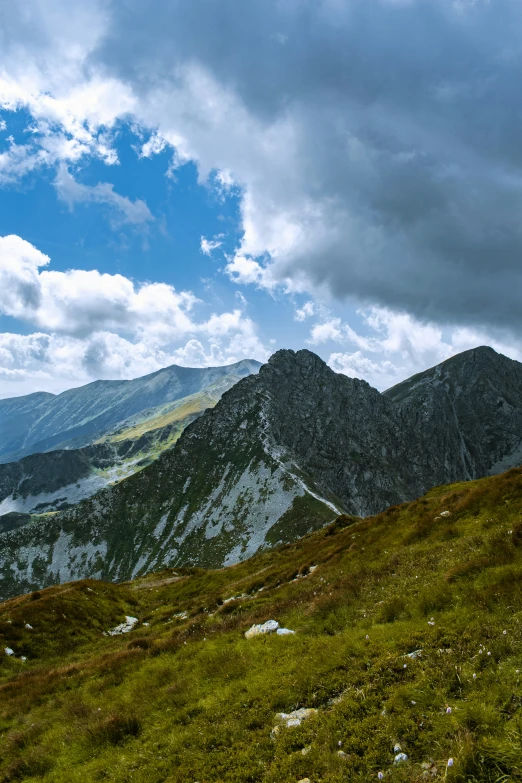 mountain views with grass and rocks under clouds