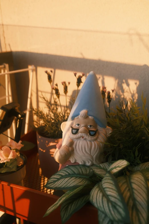 gnome statue sitting on chair next to indoor plants