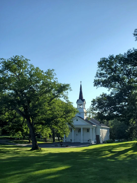 a large building on top of a lush green field