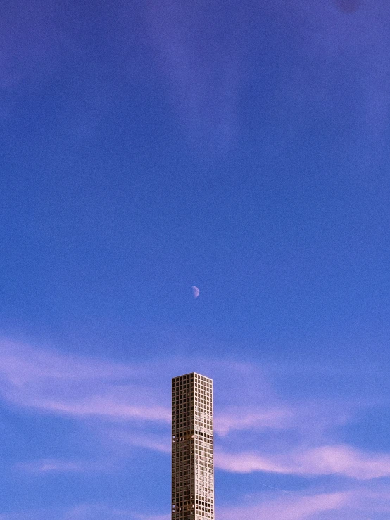 a tall white building sitting under a blue sky