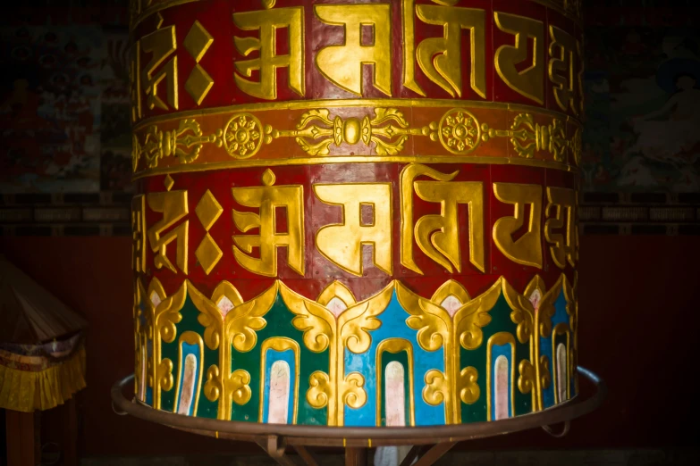 a decorative gold and red lamp with intricate writing