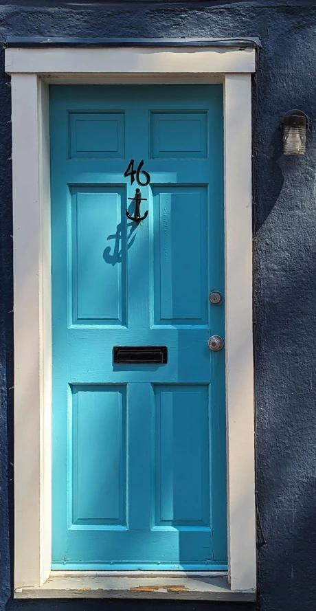 a blue door with white trim and number 46