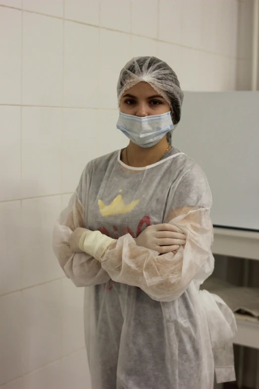 a woman wearing a surgical mask and protective clothing with bandages