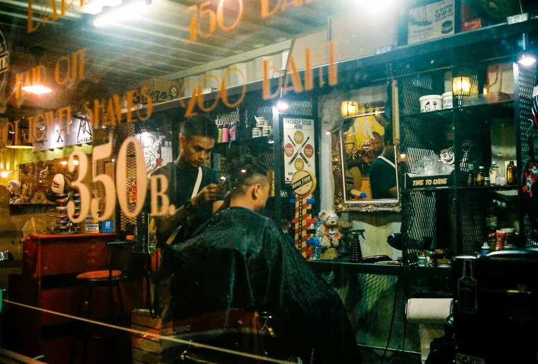 some people stand at the barbers in front of a large number of lights